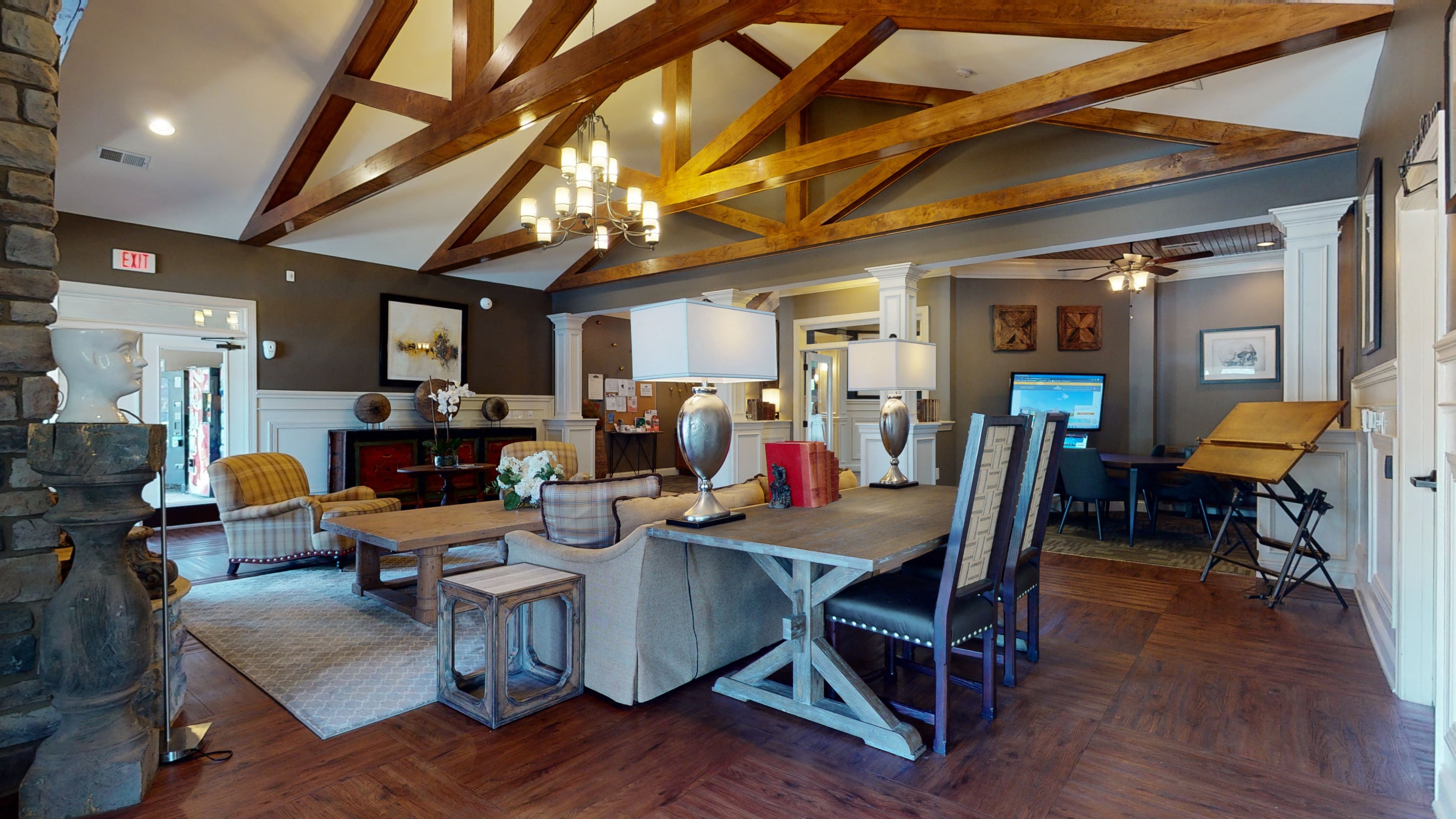 a large living room with a dining table and a fireplace