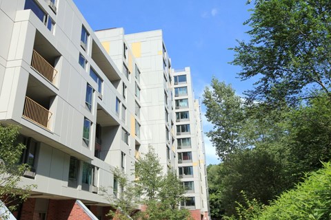 the exterior of an apartment building on a sunny day