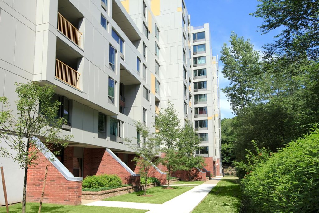 the exterior of an apartment building on a sunny day