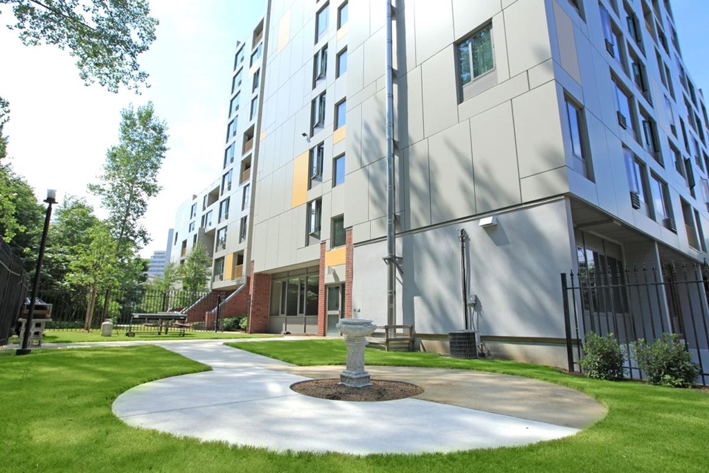 a courtyard with a fountain in front of a building