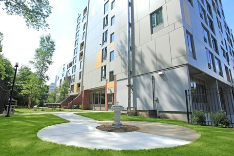a courtyard with a fountain in front of a building