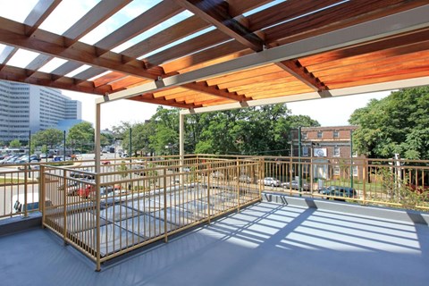 the terrace of the building has metal fences and a wooden roof