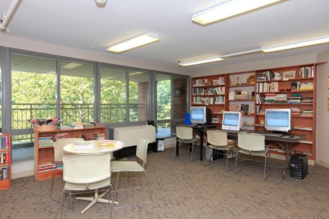 a library with desks and chairs and computers