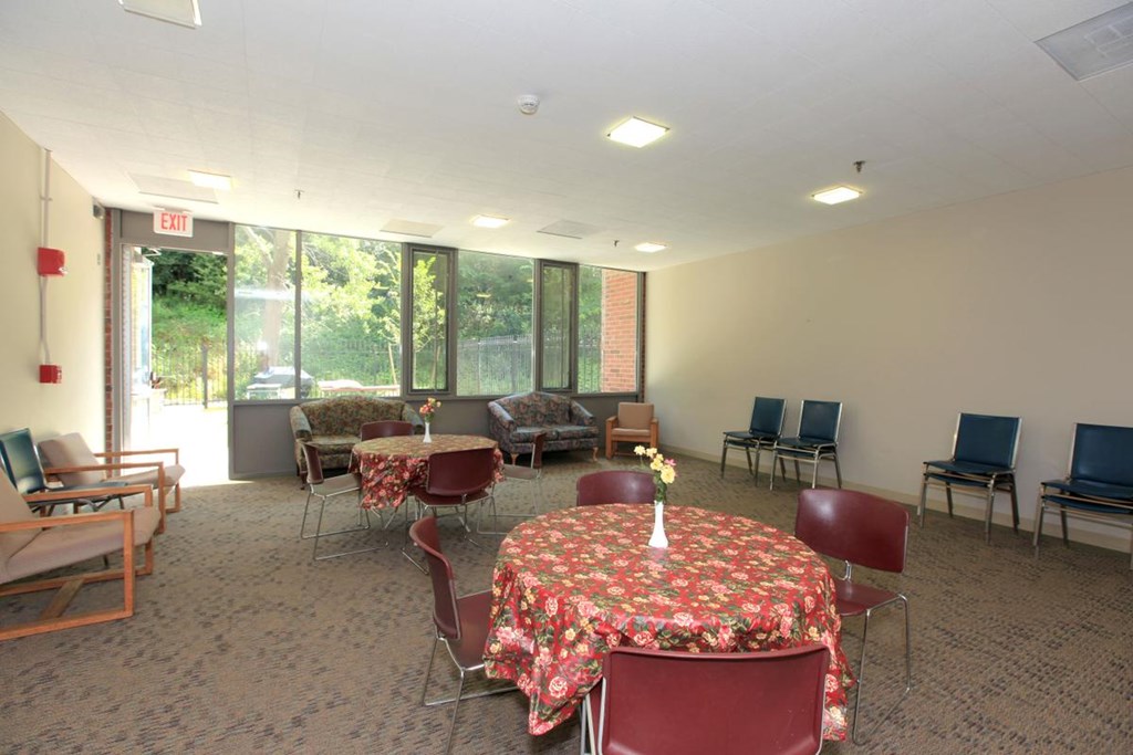 a conference room with tables and chairs and a large window