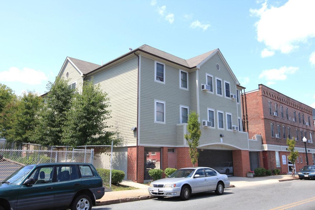 an apartment building with cars parked in front of it
