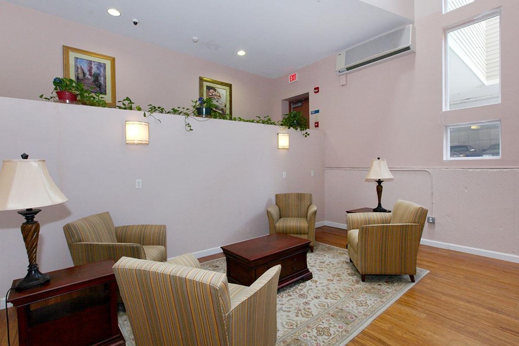 a living room with chairs and a table