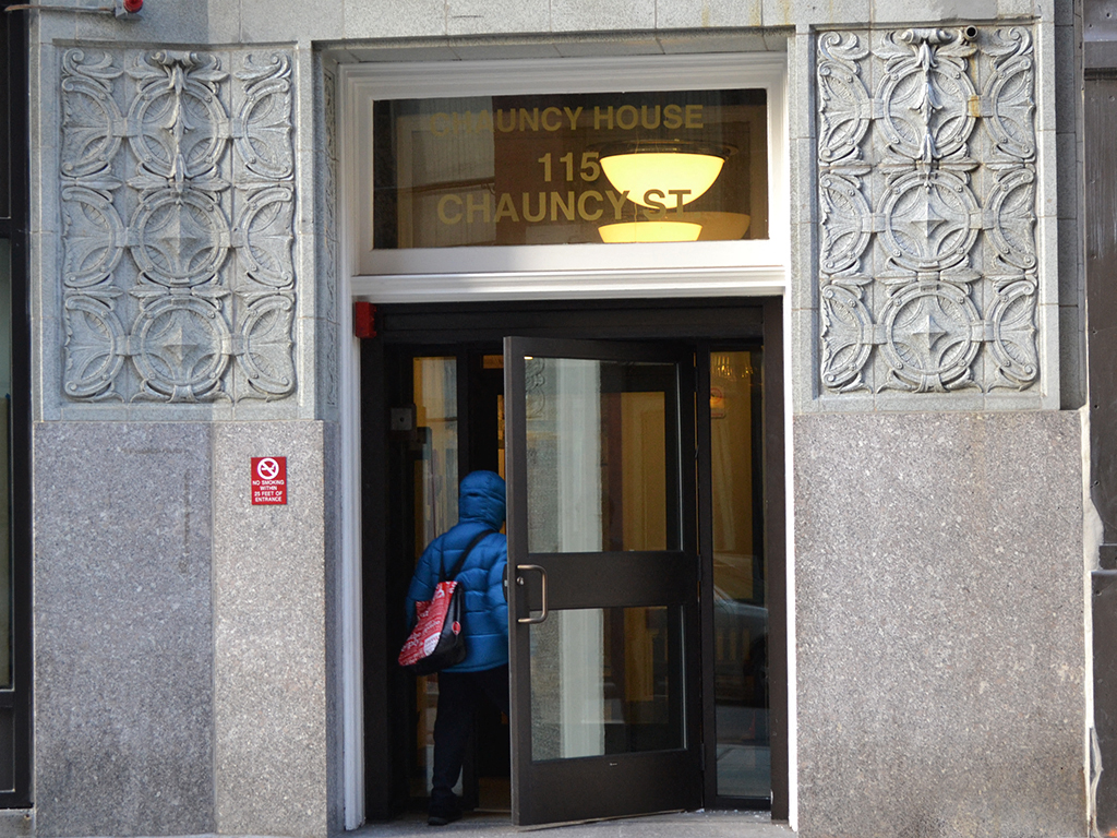 a person walking out of a door of a building
