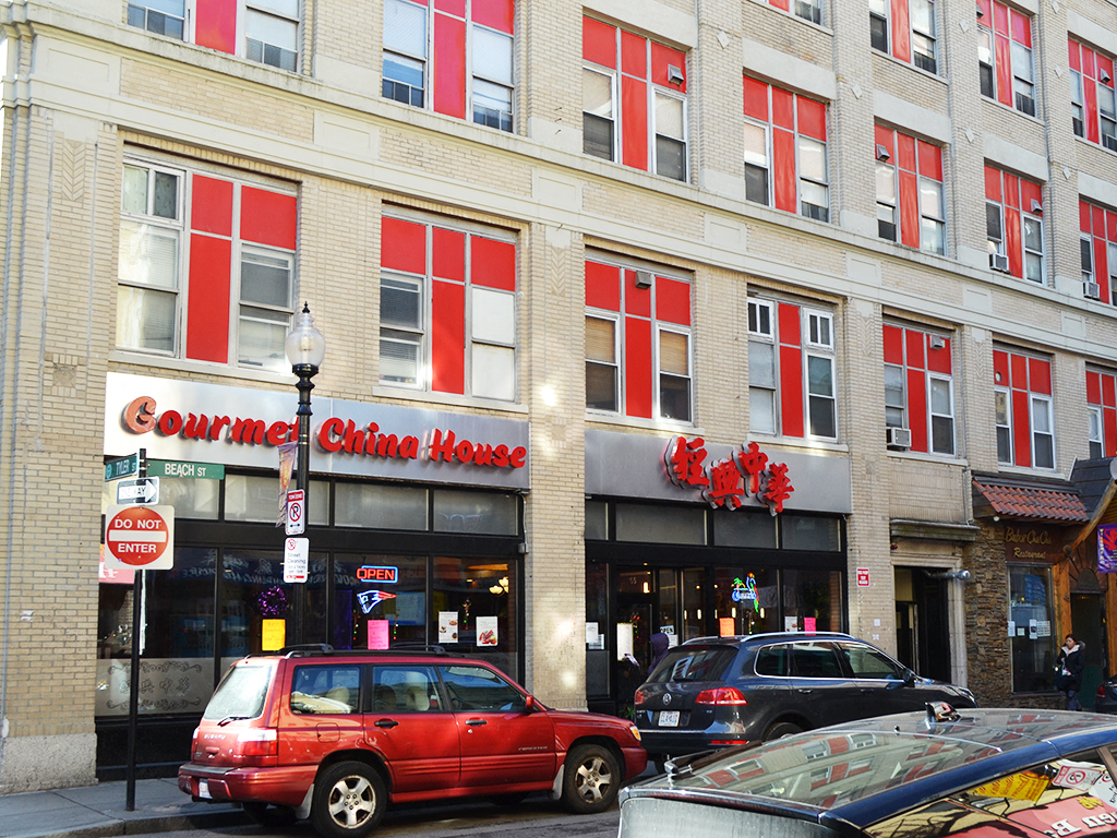 a city street with cars parked in front of a building