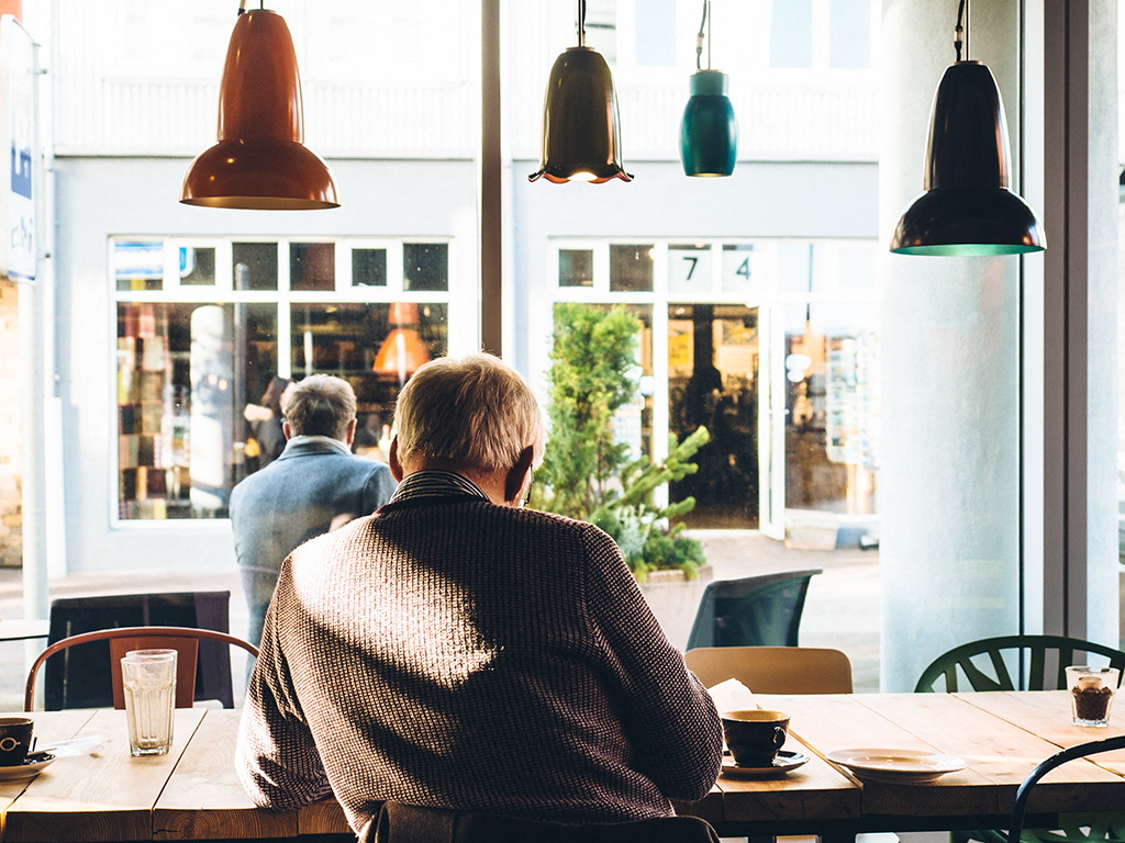 a man sitting at a table in a restaurant