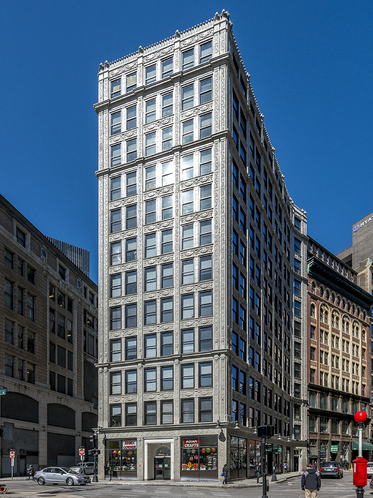 a tall building in the middle of a city street