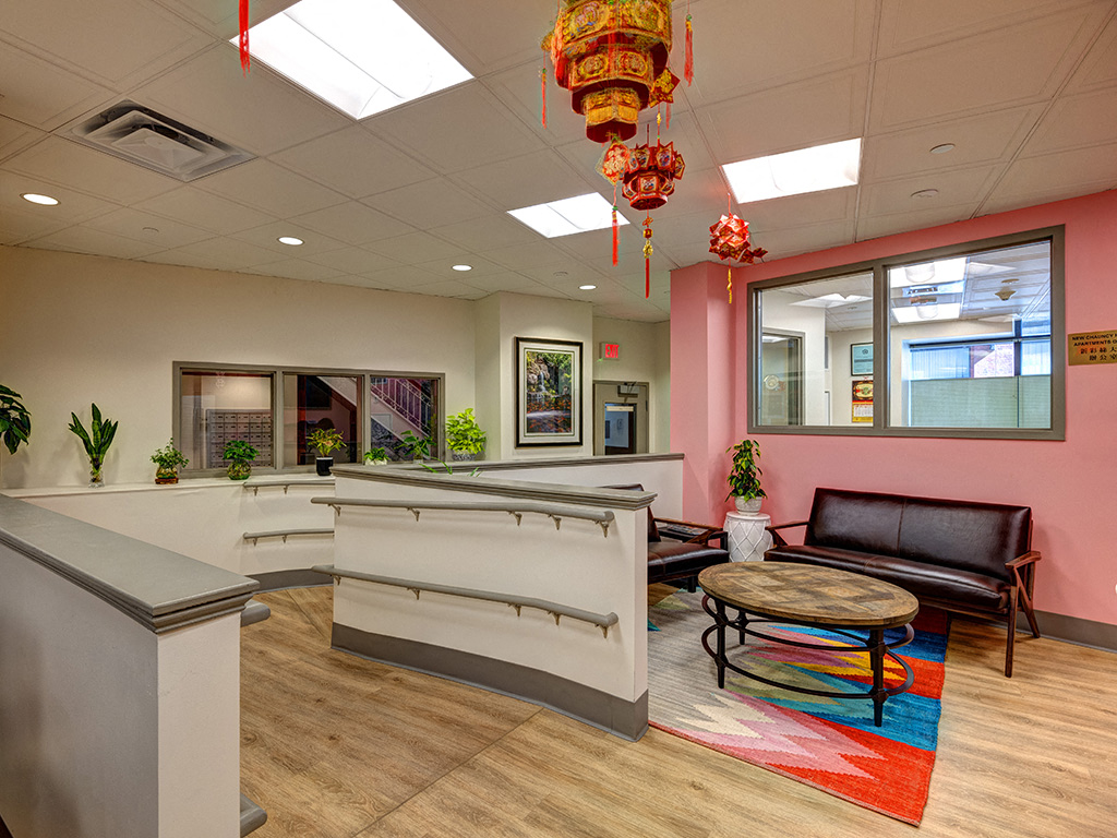 a lobby with a seating area and a reception desk