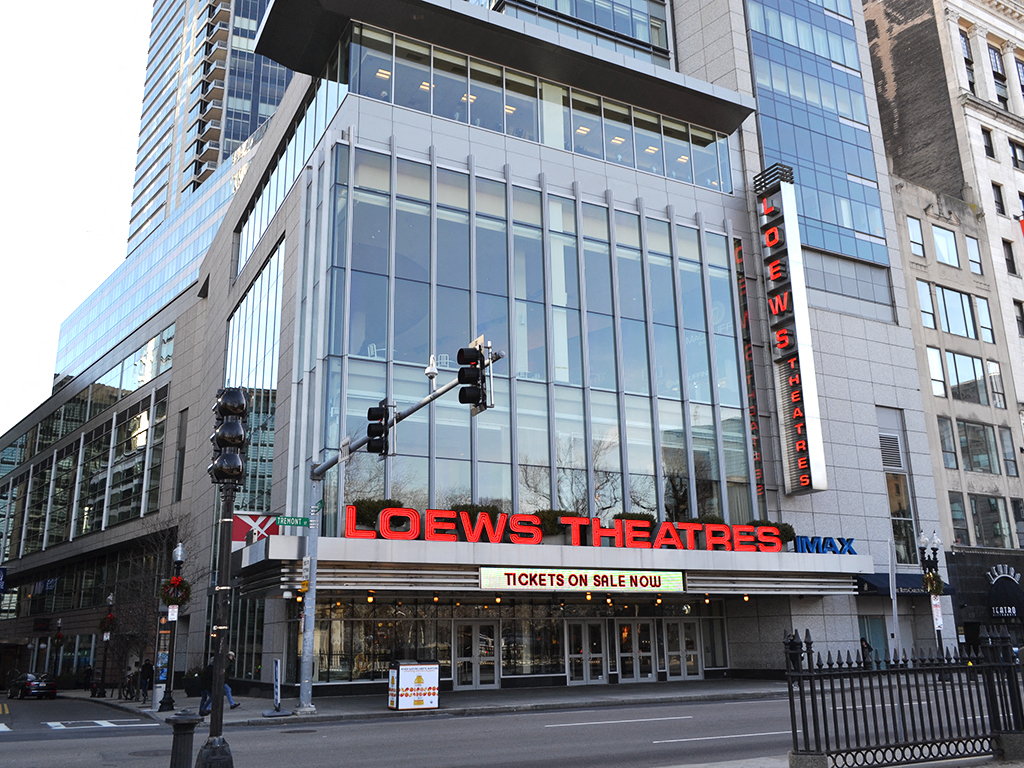 a large building with a sign on it on a city street