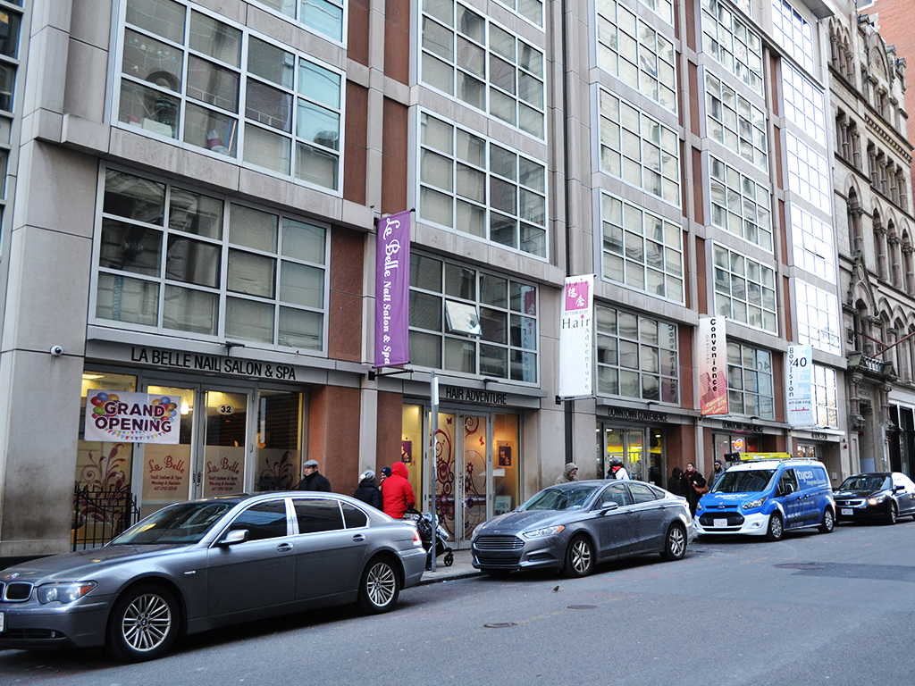 a city street with cars parked in front of a building