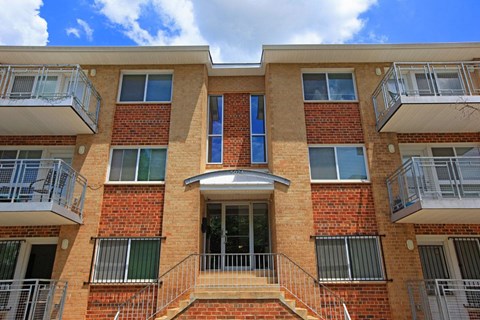 a brick building with two balconies and a door