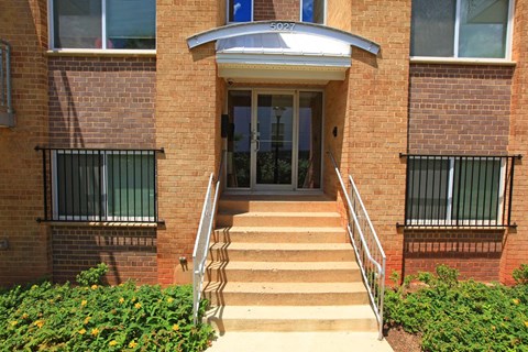 the entrance to a brick building with stairs