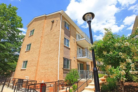 a brick apartment building with stairs and a street light
