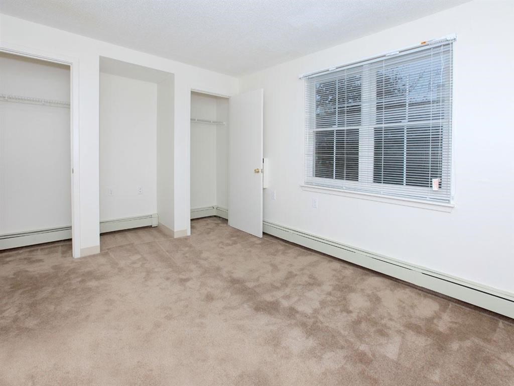 an empty room with a window and a door