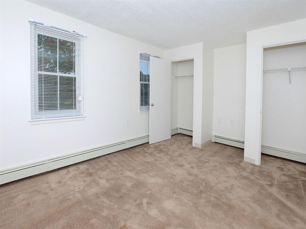 an empty room with a window and a door