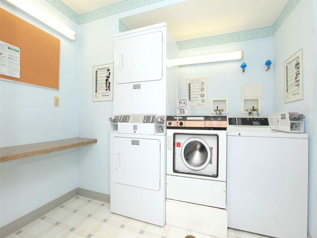 a laundry room with washing machines and a washer and dryer