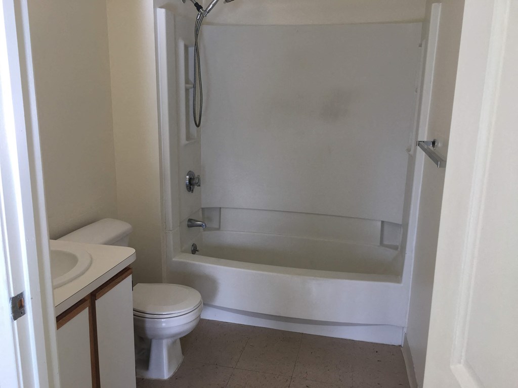 a small bathroom with a shower toilet and sink