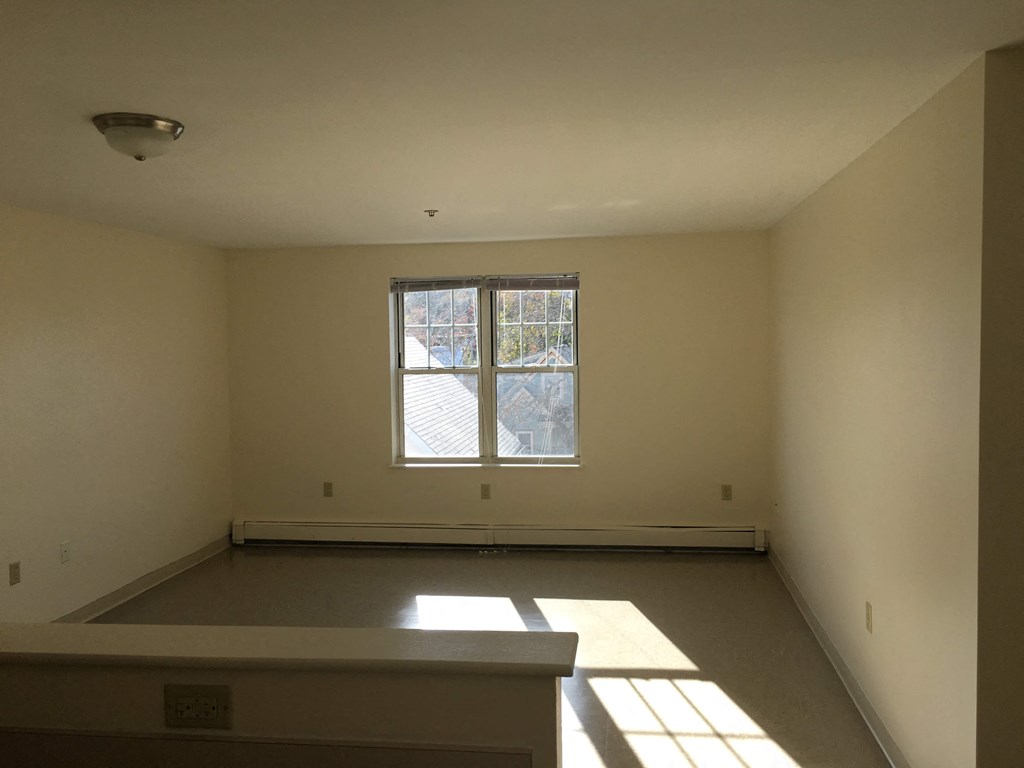 the living room of a house with a large window