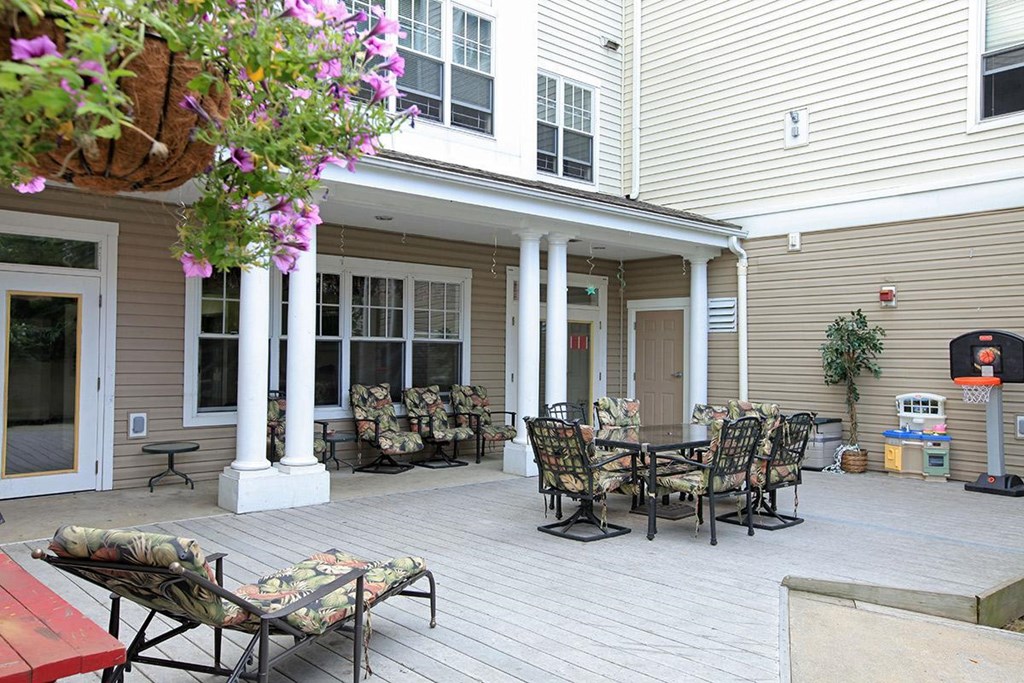 a patio with chairs and a table on a porch