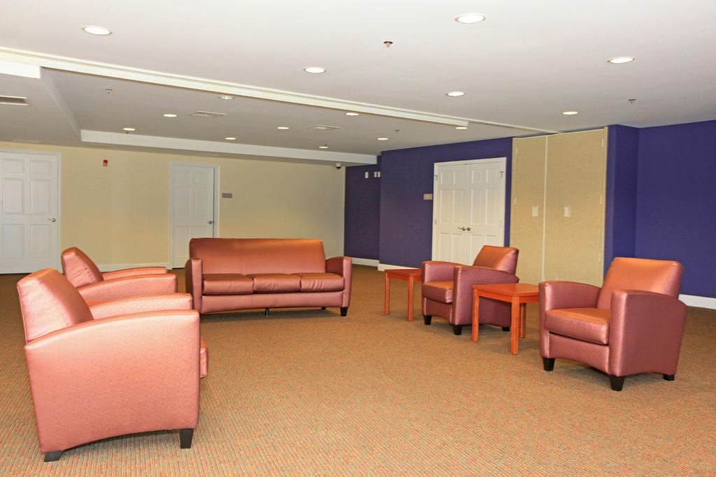 an empty waiting room with chairs and couches