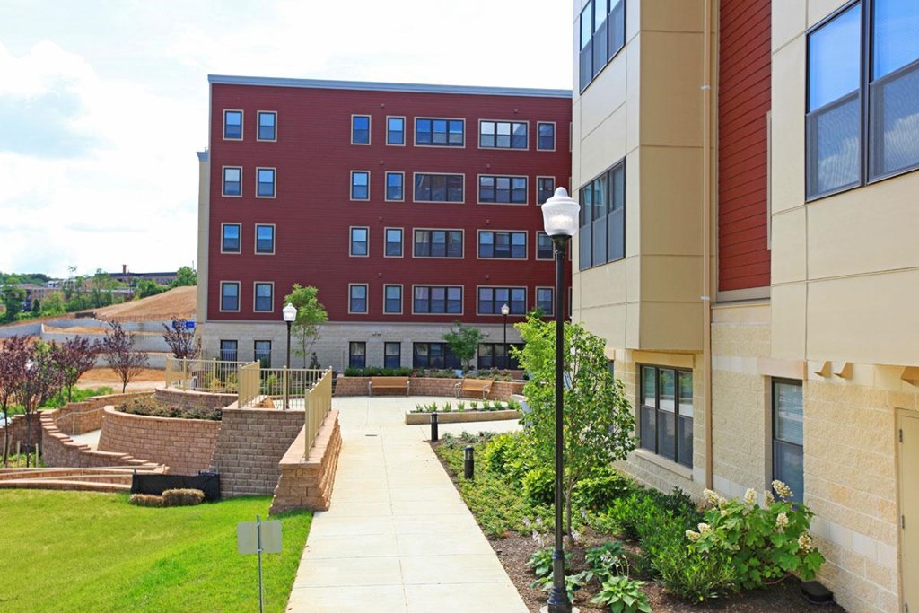 a walkway between two buildings on the campus of a university