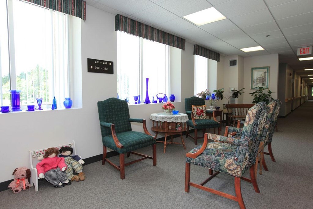 a waiting room of a hospital with chairs and dolls