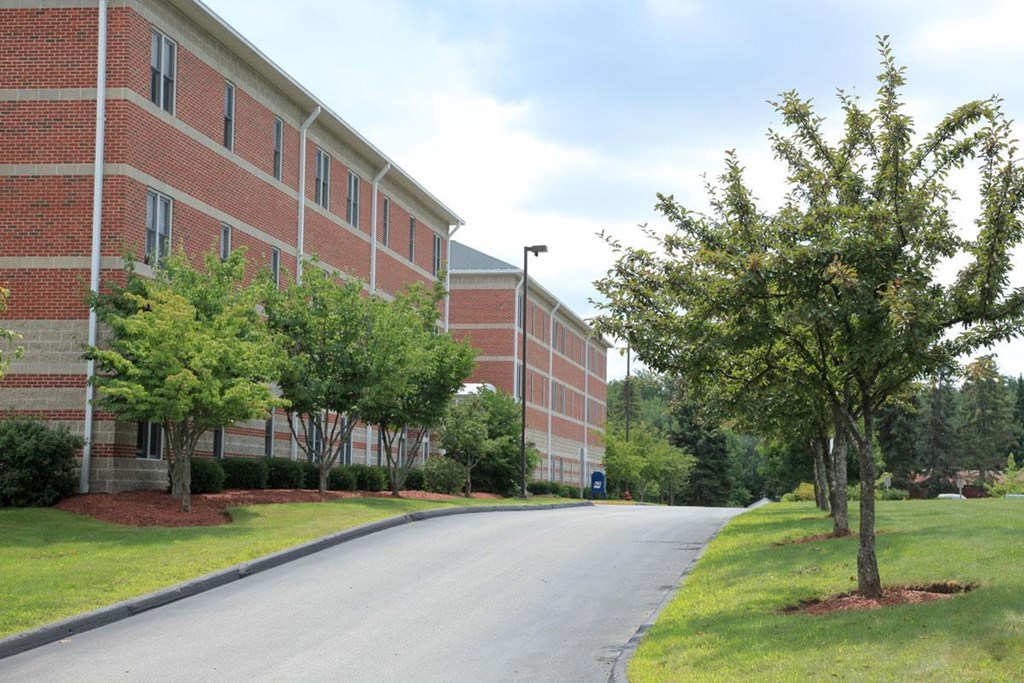 an empty street in front of a brick building