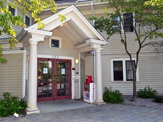 the front of the building is shown with a red door