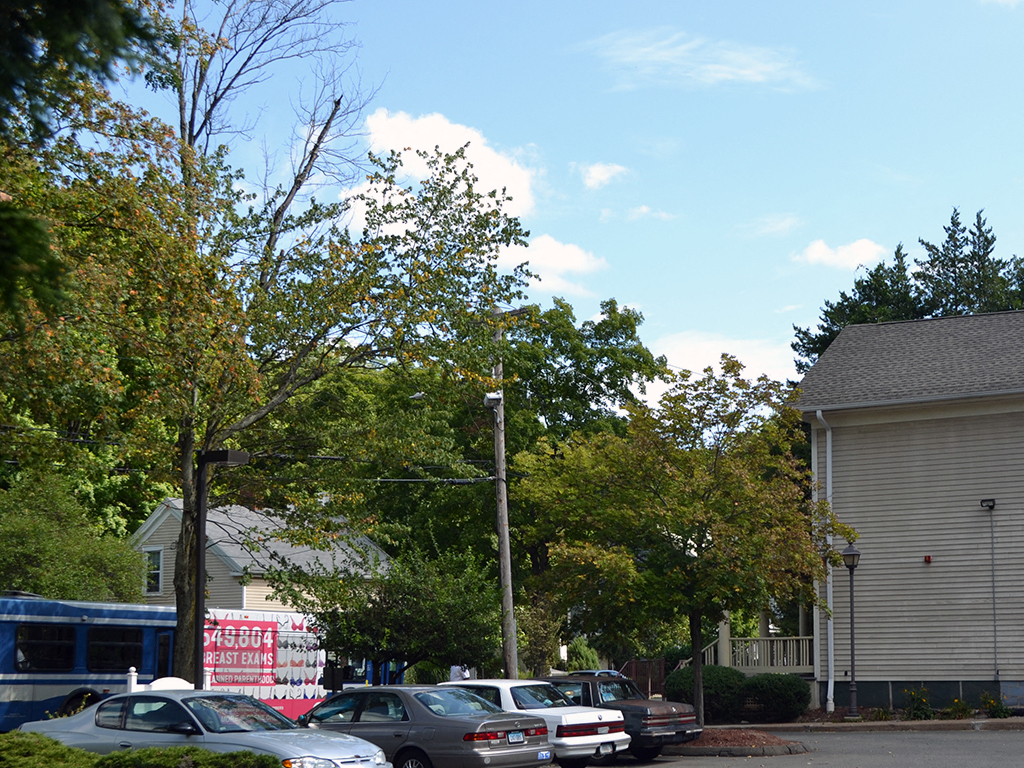 a parking lot with cars in front of a house