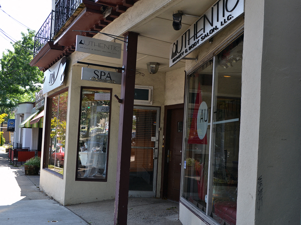 a store front of a building with a sign in the window