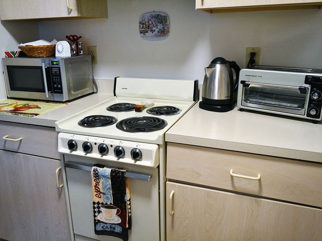 a kitchen with a stove top oven and a microwave