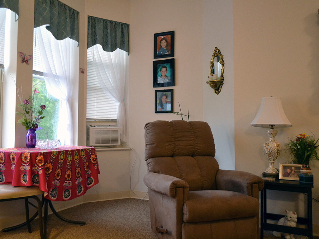 a living room with a chair and a table