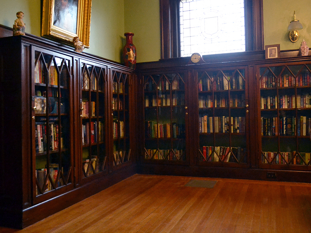 a library with wooden shelves filled with books