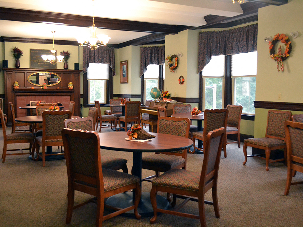 a dining room with tables and chairs and a fireplace