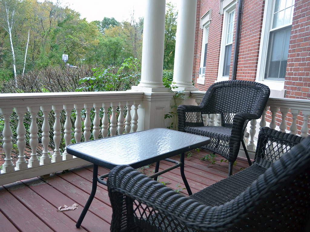 a patio with a table and chairs on a porch