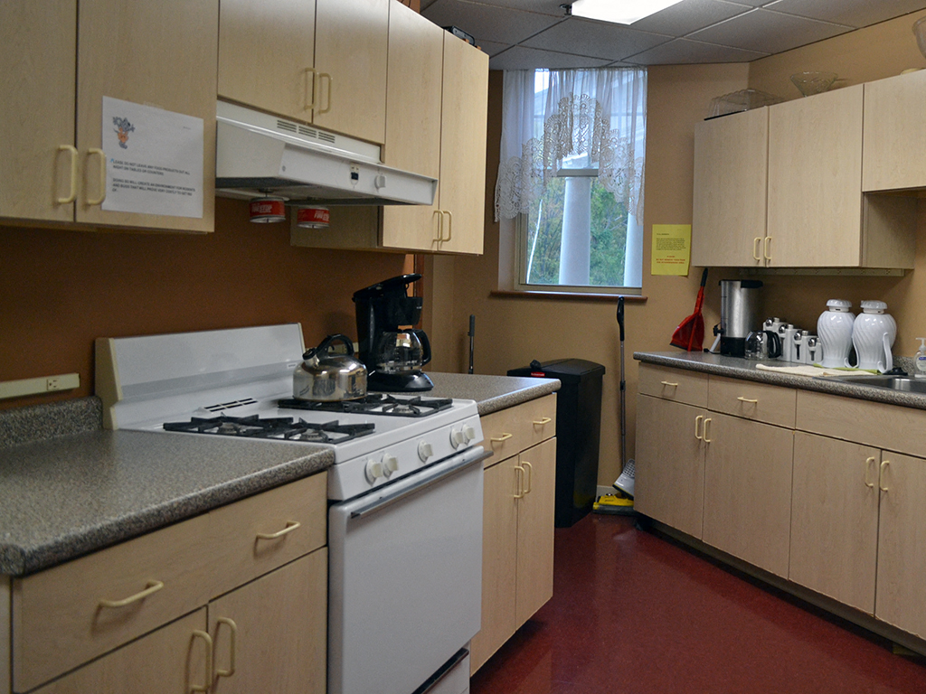a kitchen with a stove and a window
