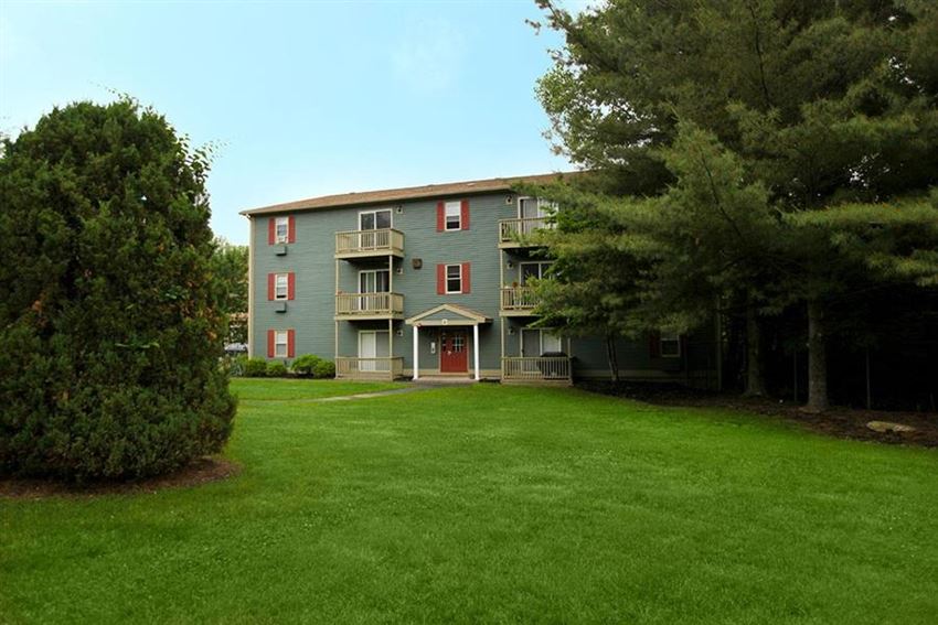 a large green lawn in front of an apartment building