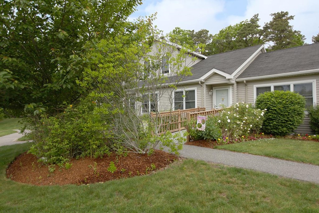 the front yard of a house with a garden and a pathway