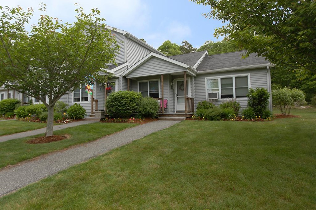 a gray house with a sidewalk in front of it