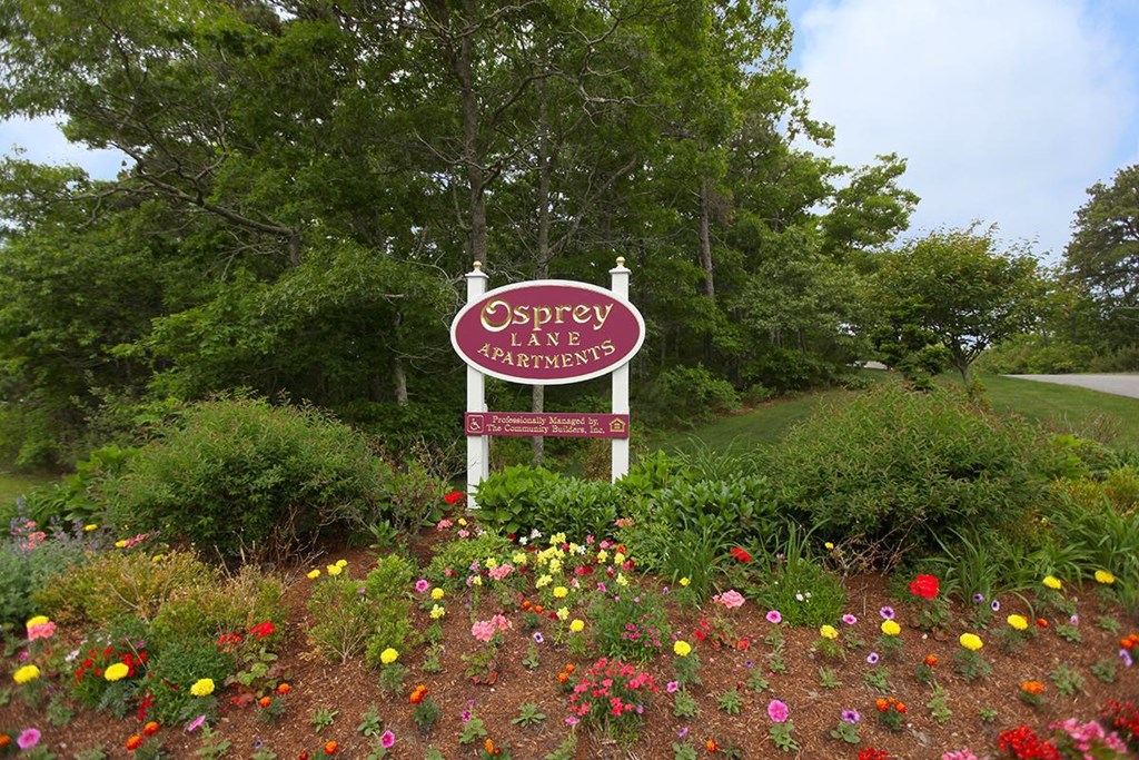 a sign in a field of flowers