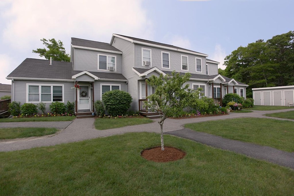 the front of a house with a yard and sidewalk