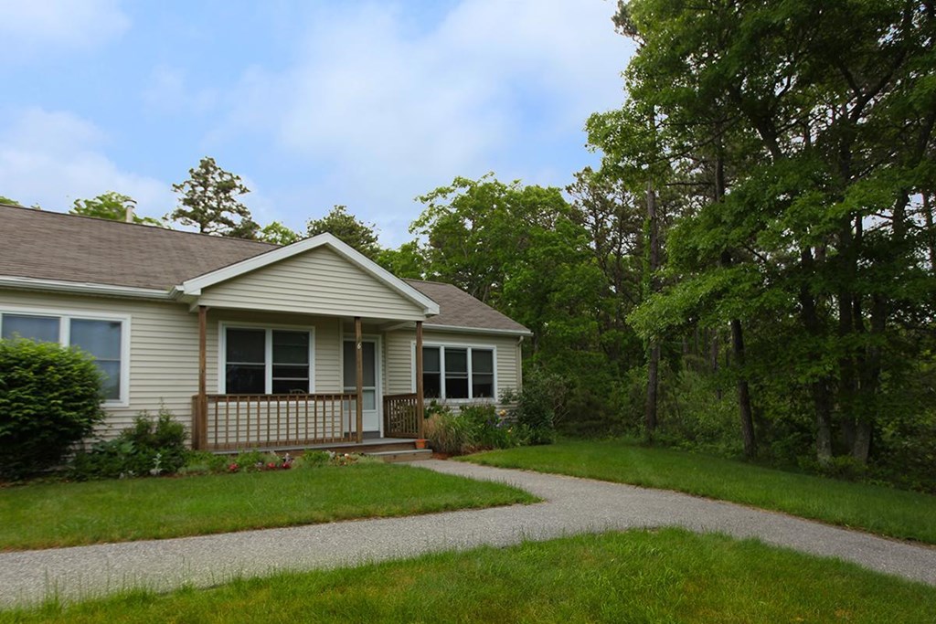 the front of the house with a walkway leading up to it