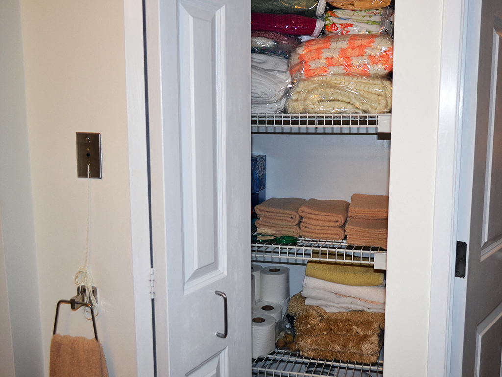 the linen closet is stocked with towels and linens