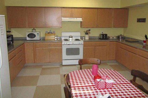 a kitchen with a table with a checkered table cloth