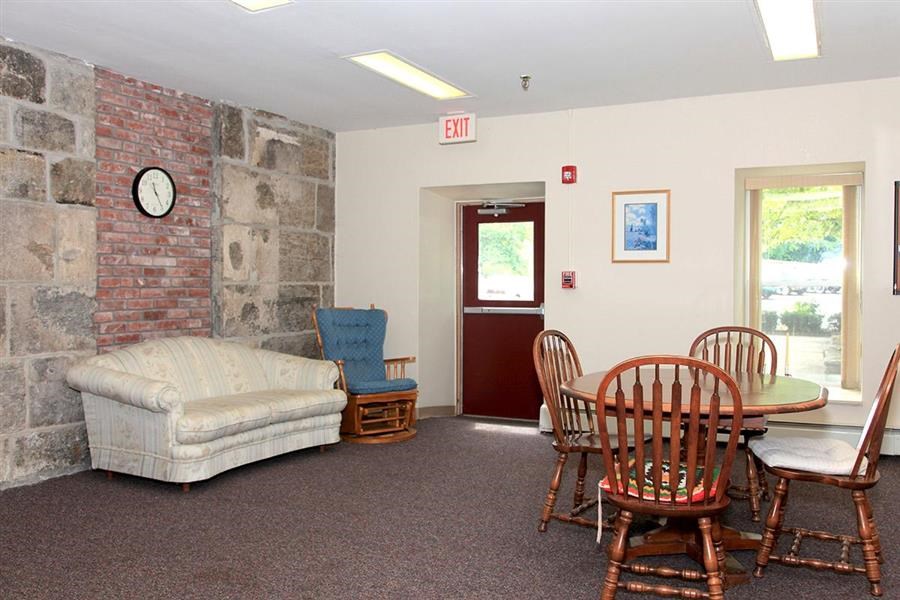 a living room with a couch and a table with chairs