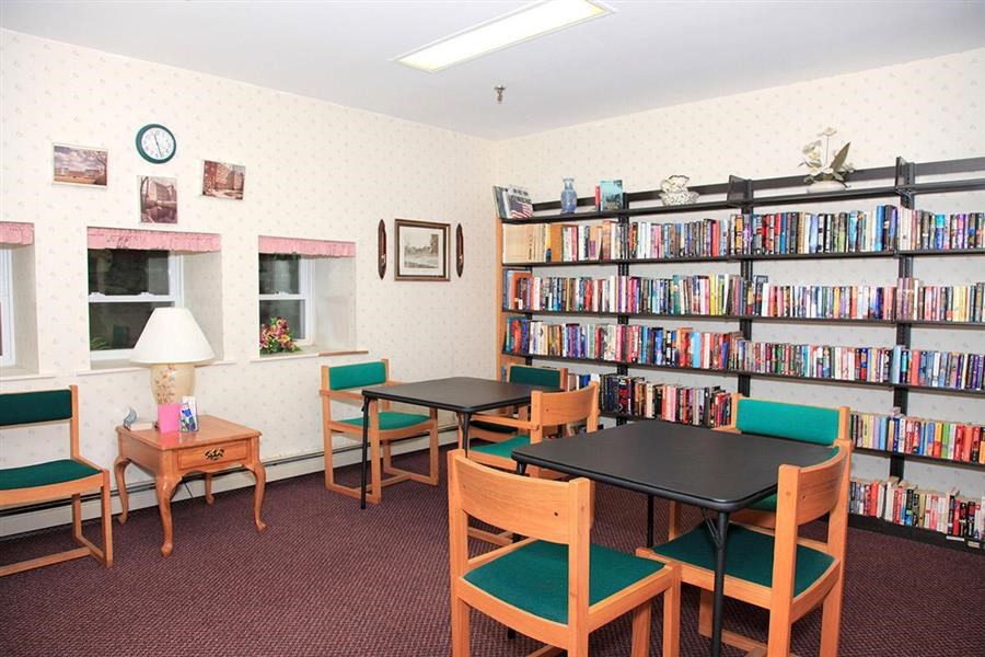 a library with tables and chairs and book shelves