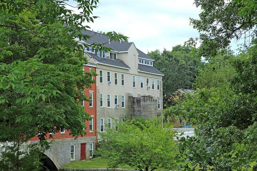 a large building with trees in front of it